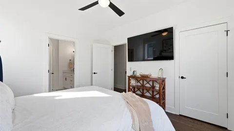 a bedroom with a bed and a television