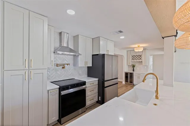 a kitchen with stainless steel appliances a refrigerator sink and cabinets