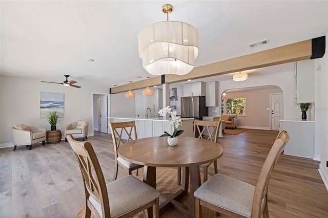 a view of a dining room with furniture and wooden floor