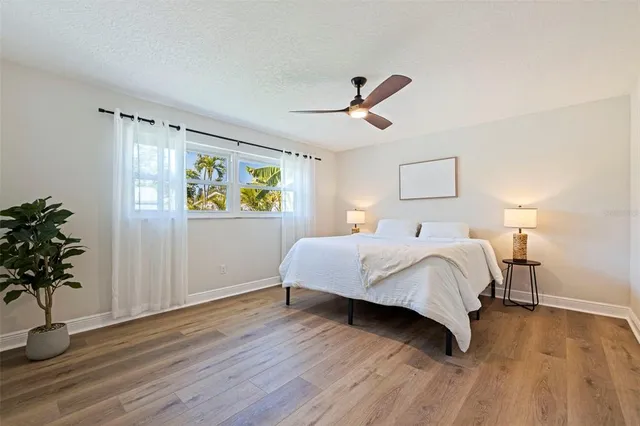 a bedroom with a bed and a potted plant