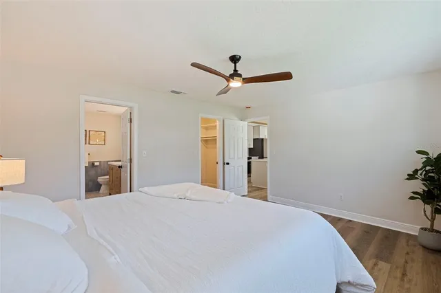 a bedroom with a large bed and a chandelier