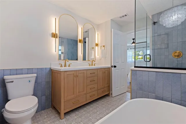 a bathroom with a sink a toilet and mirror