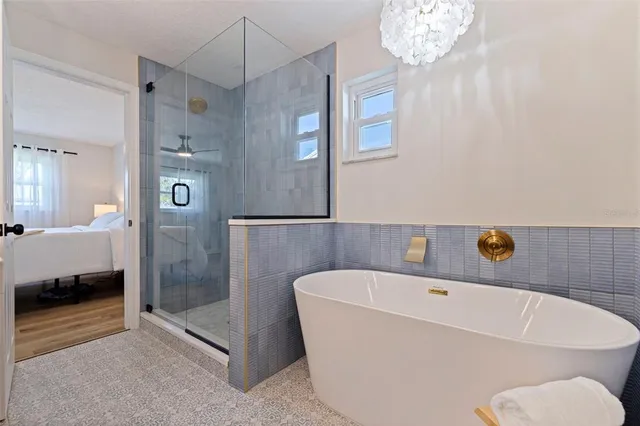 a bathroom with a tub and a shower