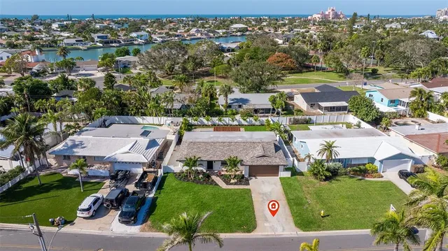 an aerial view of residential houses with outdoor space and parking