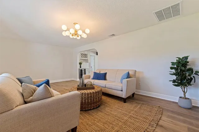 a living room with furniture flowerpot and a window