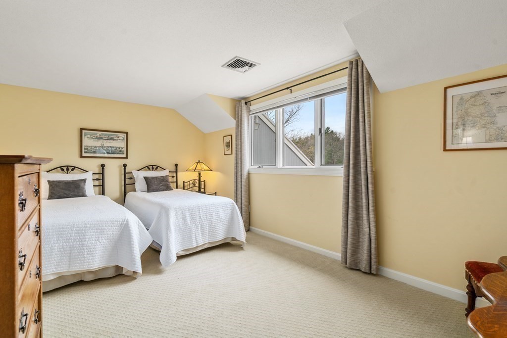 1 Pickwick Way, Unit 1 Wayland, MA 01778 - Photo 16 of 32 a spacious bedroom with two beds and painting on the wall
