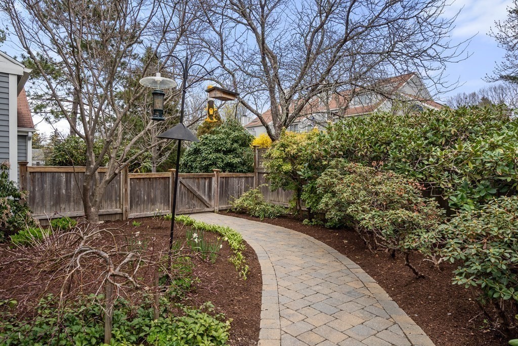 1 Pickwick Way, Unit 1 Wayland, MA 01778 - Photo 2 of 32 a backyard with plants and trees