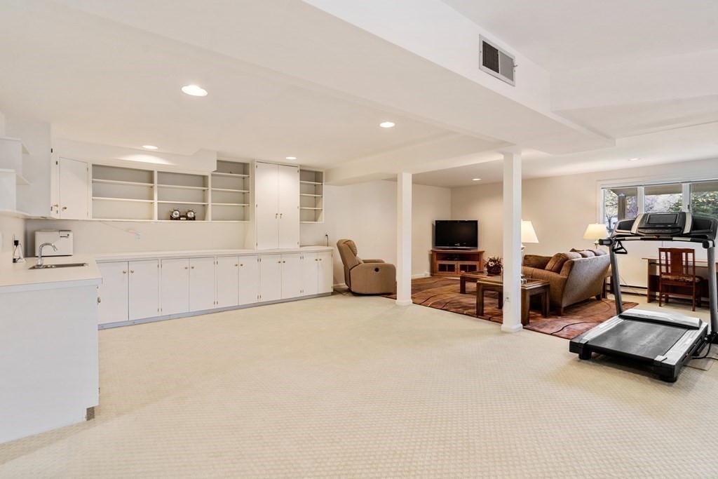 1 Pickwick Way, Unit 1 Wayland, MA 01778 - Photo 24 of 32 a large bedroom with furniture and a flat screen tv
