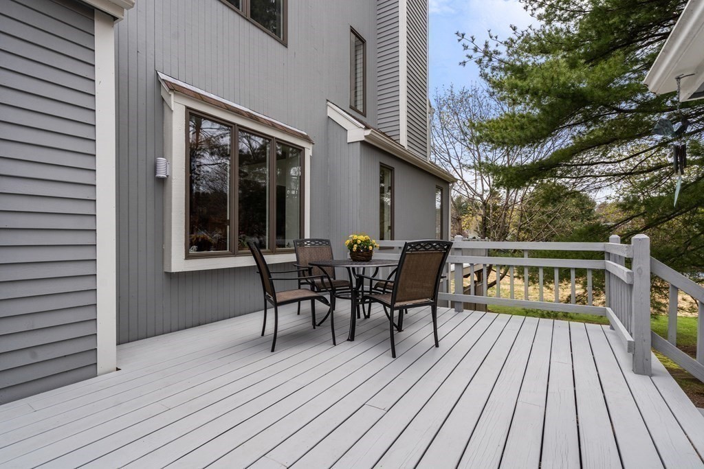 1 Pickwick Way, Unit 1 Wayland, MA 01778 - Photo 27 of 32 a view of a house with a deck and furniture