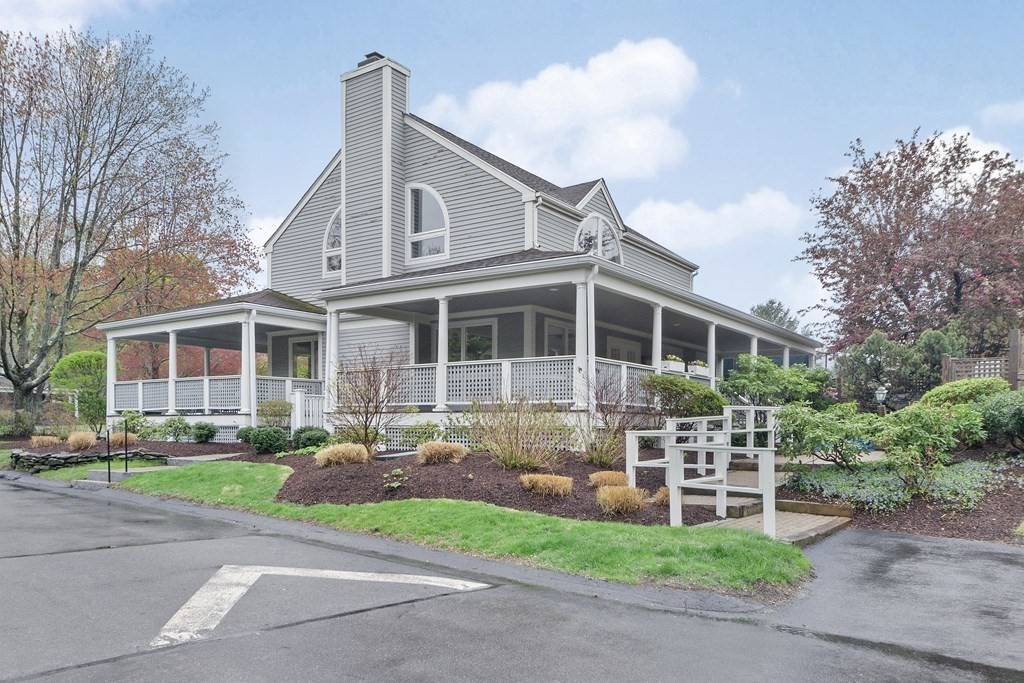 1 Pickwick Way, Unit 1 Wayland, MA 01778 - Photo 30 of 32 a front view of a house with garden and trees