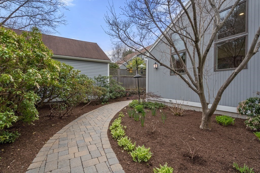 1 Pickwick Way, Unit 1 Wayland, MA 01778 - Photo 3 of 32 a front view of a house with garden