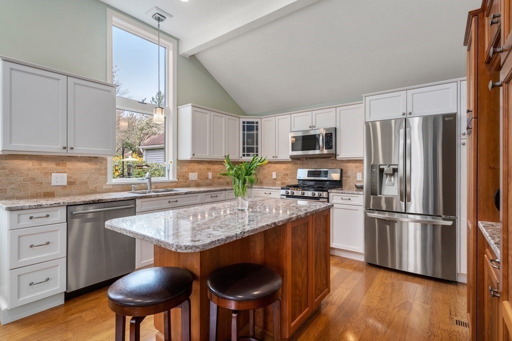 1 Pickwick Way, Unit 1 Wayland, MA 01778 - Photo 5 of 32 a kitchen with stainless steel appliances granite countertop a stove top oven a refrigerator a sink and a stove