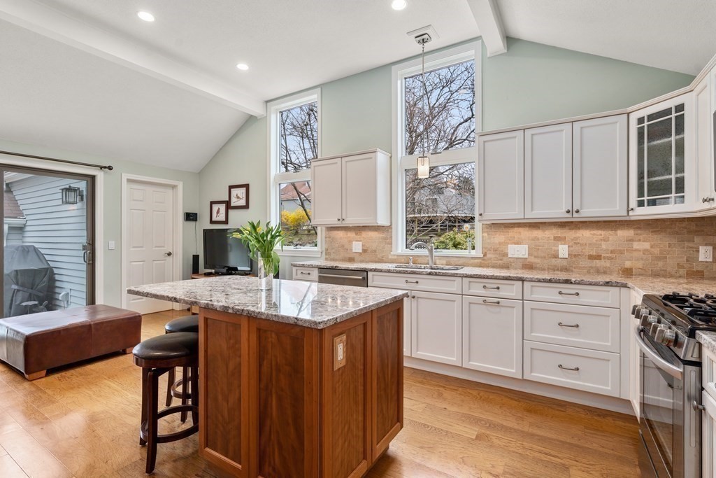 1 Pickwick Way, Unit 1 Wayland, MA 01778 - Photo 6 of 32 a kitchen with stainless steel appliances granite countertop a sink and cabinets