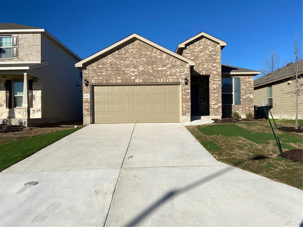 200 Kildeer Pass Jarrell, TX 76537 - Photo 2 of 27 a front view of a house with garden