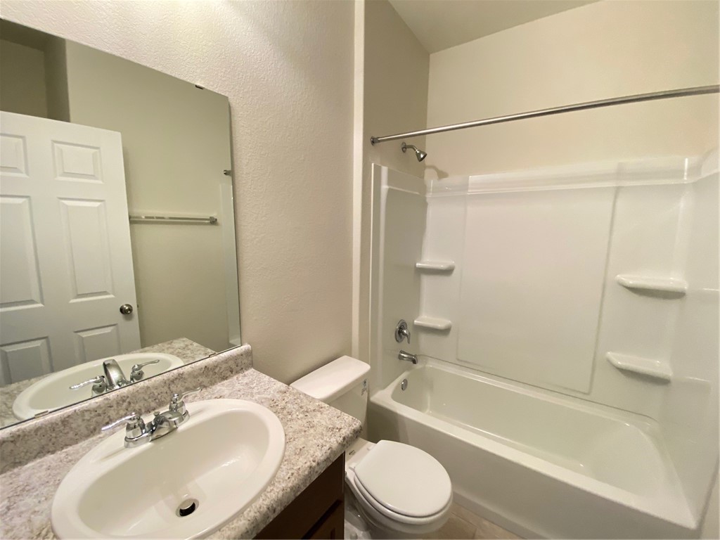 200 Kildeer Pass Jarrell, TX 76537 - Photo 24 of 27 a bathroom with a granite countertop sink toilet and shower