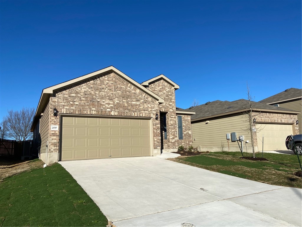 200 Kildeer Pass Jarrell, TX 76537 - Photo 3 of 27 a view of a house with a yard and garage
