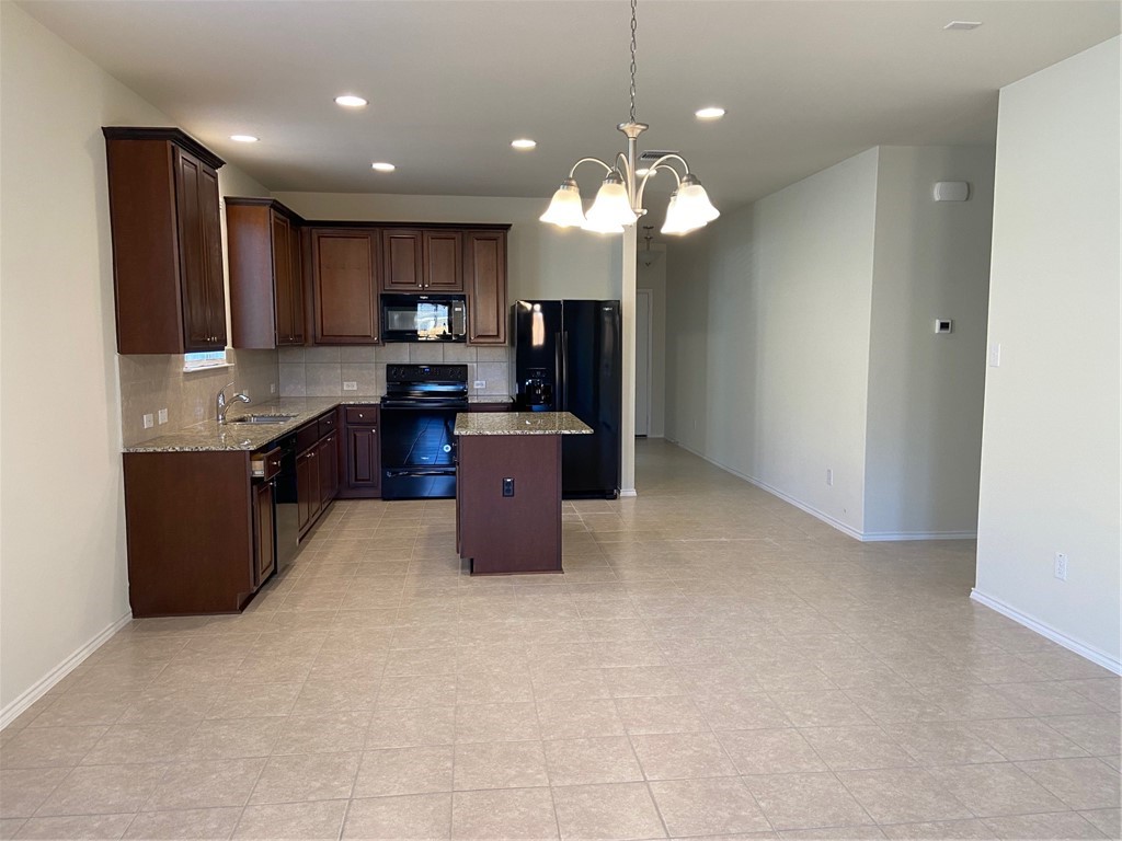 200 Kildeer Pass Jarrell, TX 76537 - Photo 10 of 27 a kitchen with stainless steel appliances granite countertop a refrigerator and a view of kitchen