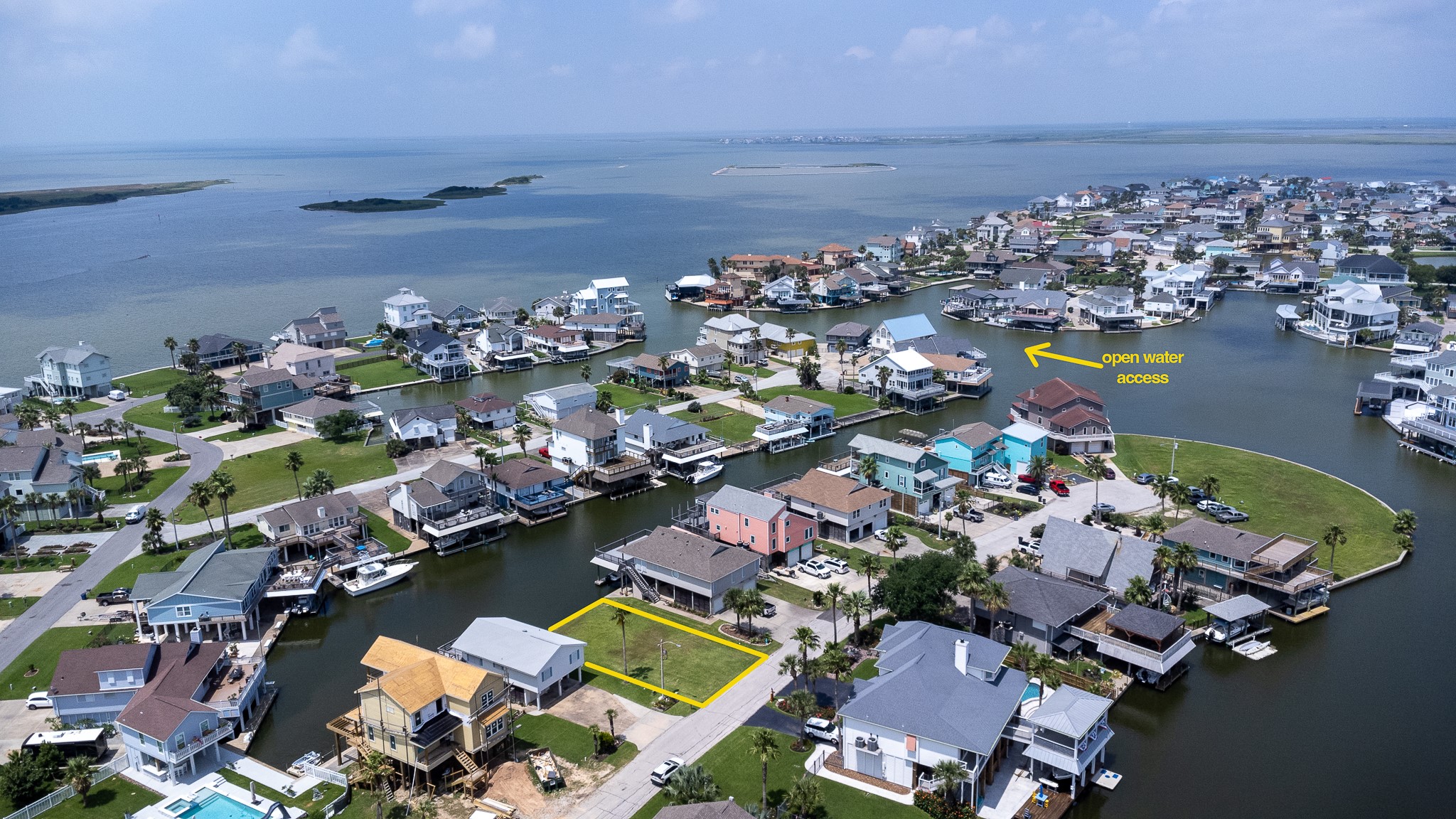 Lot 46 Bamboo Road Tiki Island, TX 77554 - Photo 17 of 23 an aerial view of a house with a swimming pool yard and lake view in back