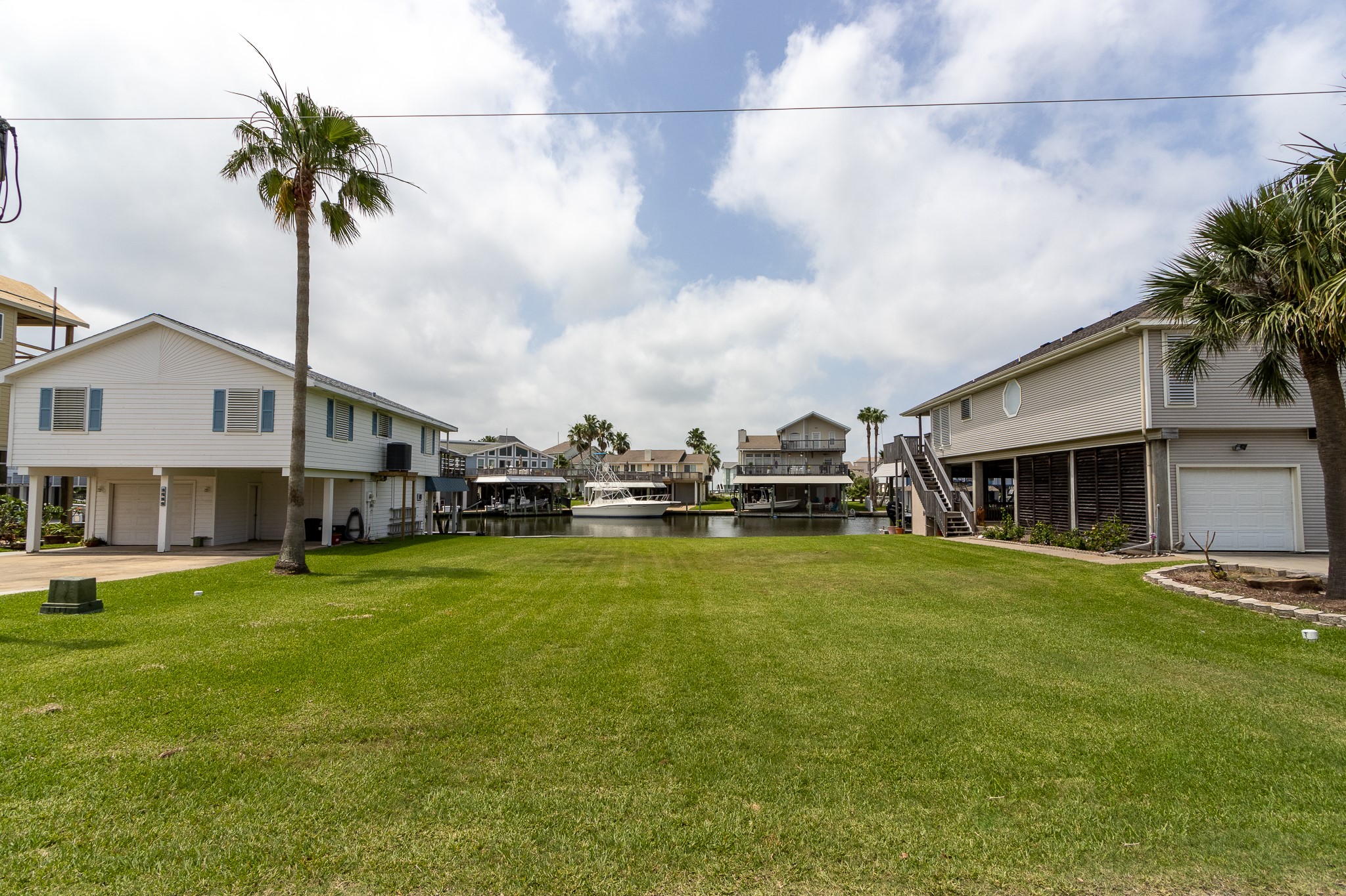 Lot 46 Bamboo Road Tiki Island, TX 77554 - Photo 5 of 23 a front view of a house with a garden and trees