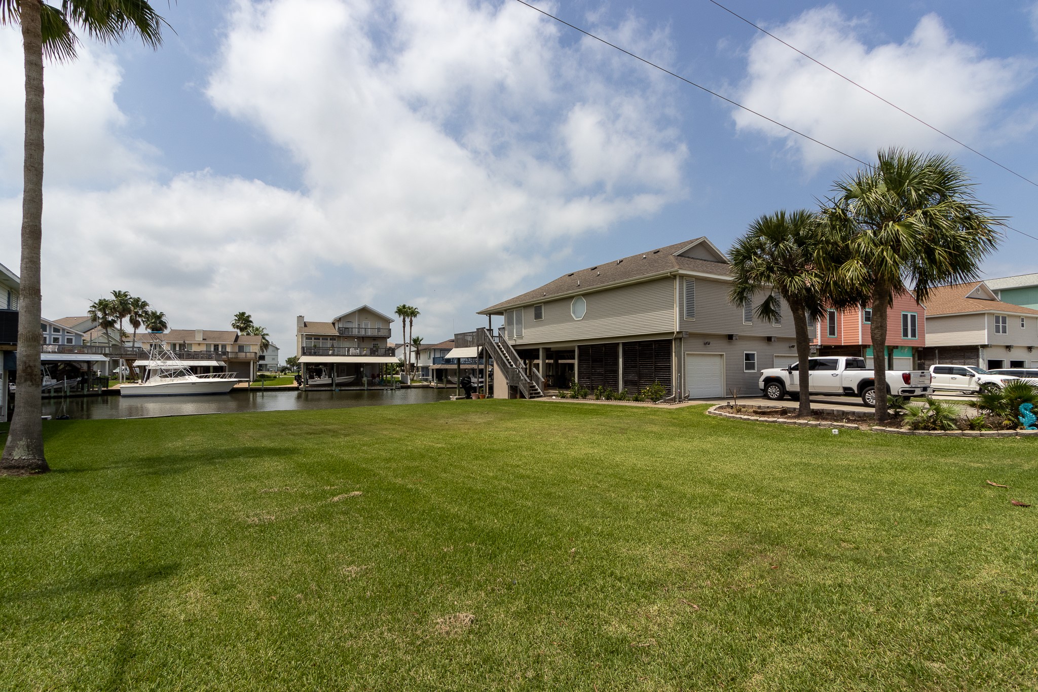 Lot 46 Bamboo Road Tiki Island, TX 77554 - Photo 6 of 23 a view of a swimming pool with lawn chairs and plants