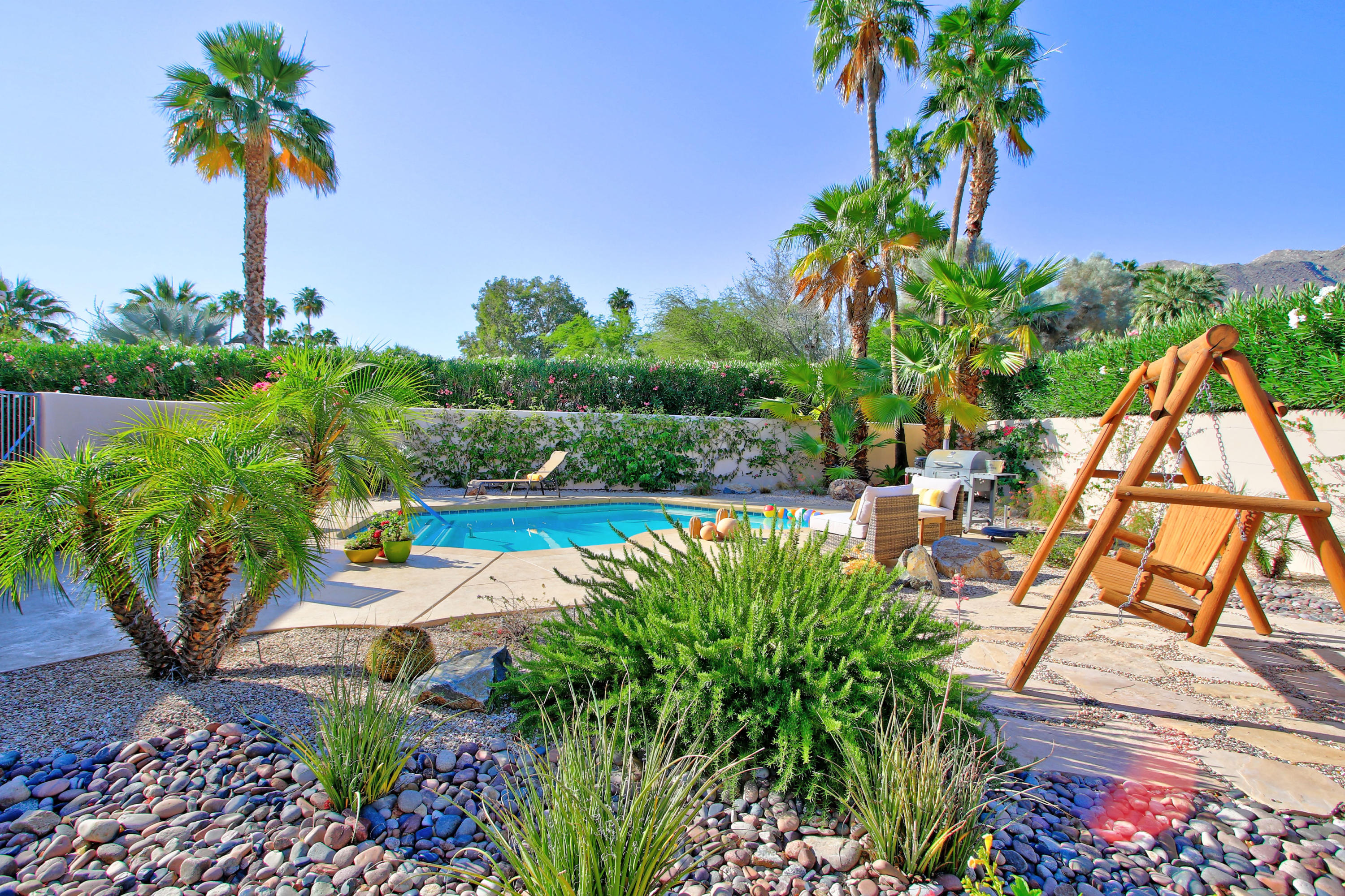 42490 Dunes View Road Rancho Mirage, CA 92270 - Photo 11 of 60 a view of a backyard with plants and a patio