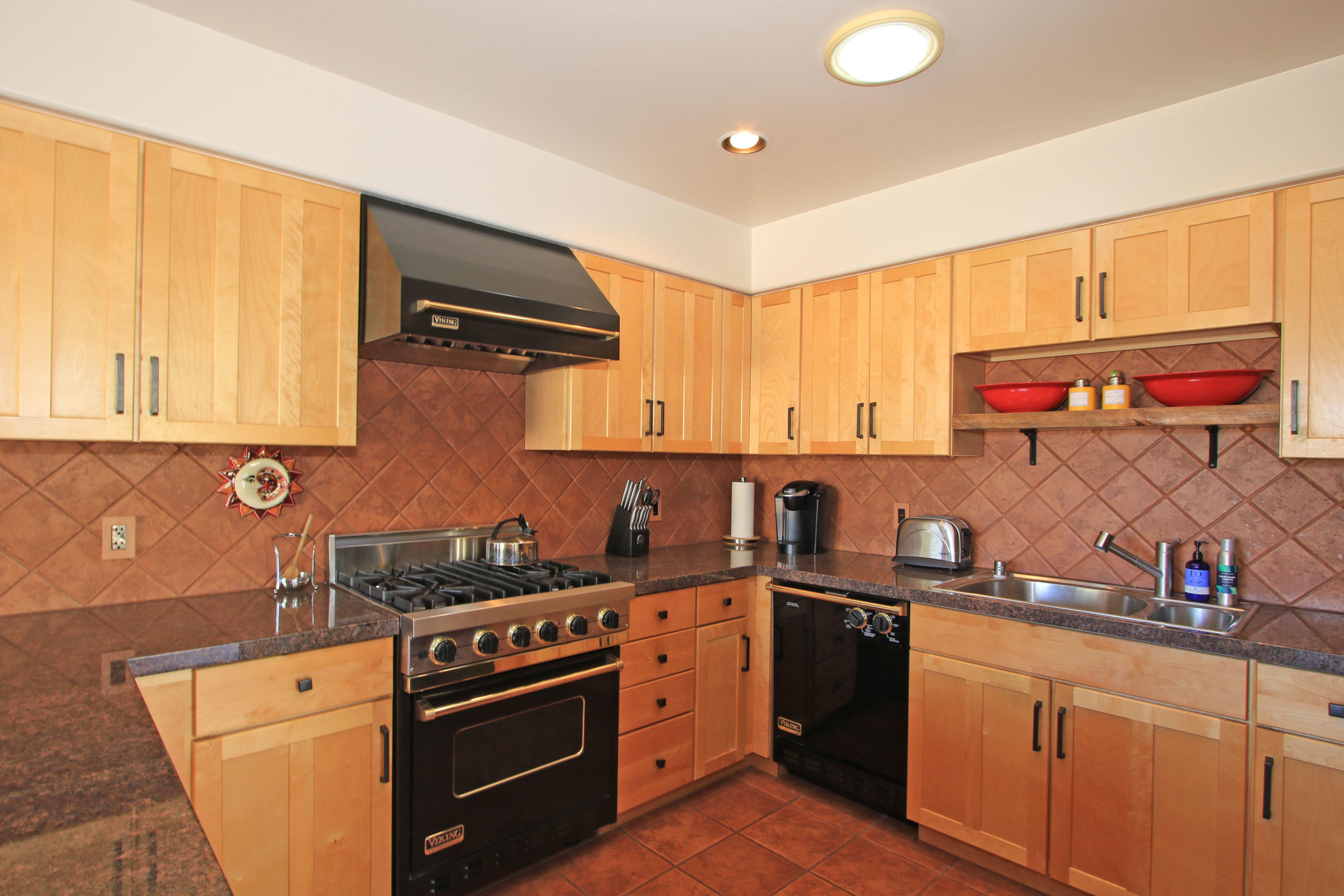 42490 Dunes View Road Rancho Mirage, CA 92270 - Photo 26 of 60 a kitchen with stainless steel appliances granite countertop a sink and cabinets