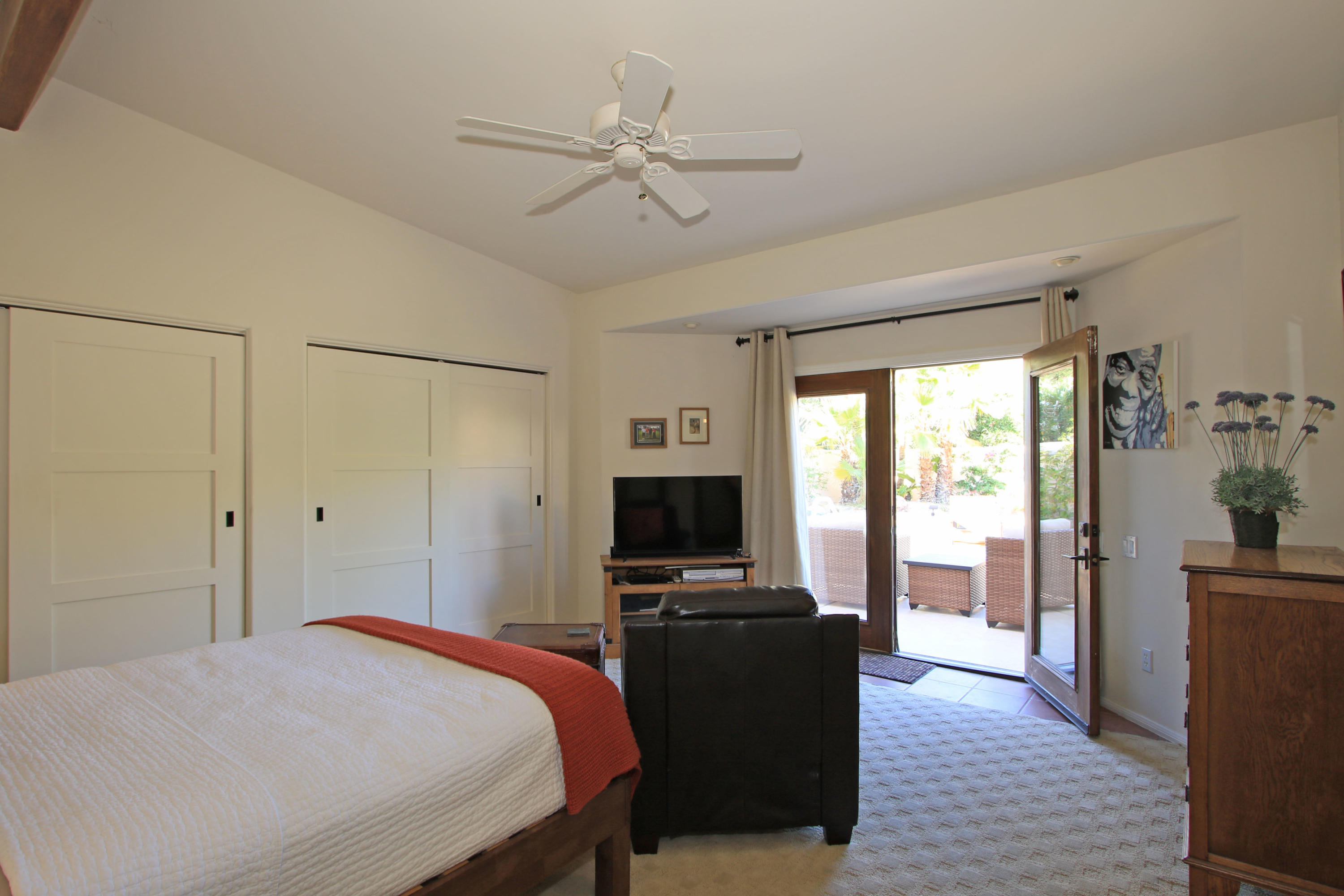 42490 Dunes View Road Rancho Mirage, CA 92270 - Photo 32 of 60 a bedroom with a bed and wooden floor