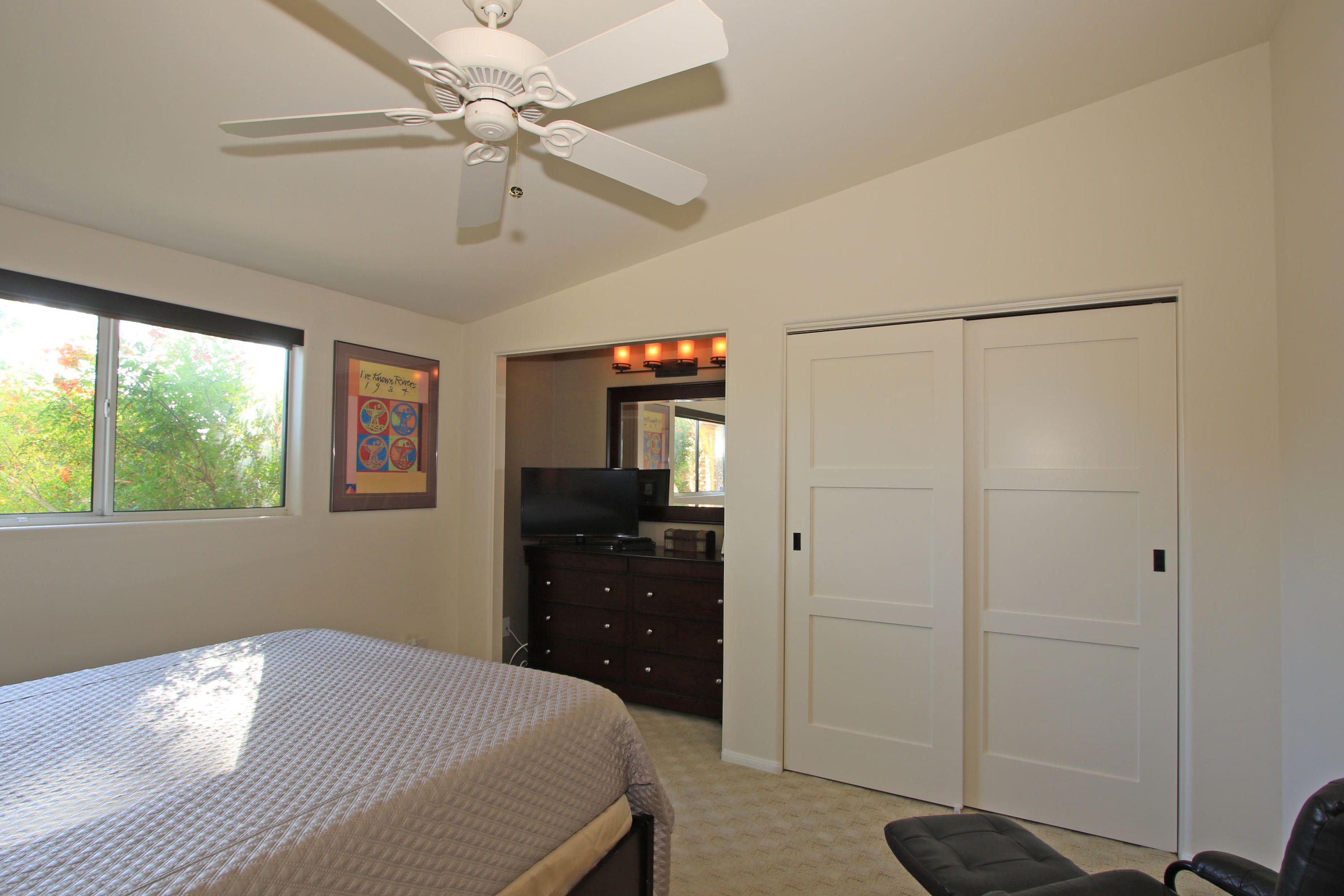 42490 Dunes View Road Rancho Mirage, CA 92270 - Photo 42 of 60 a bedroom with a bed and a chandelier