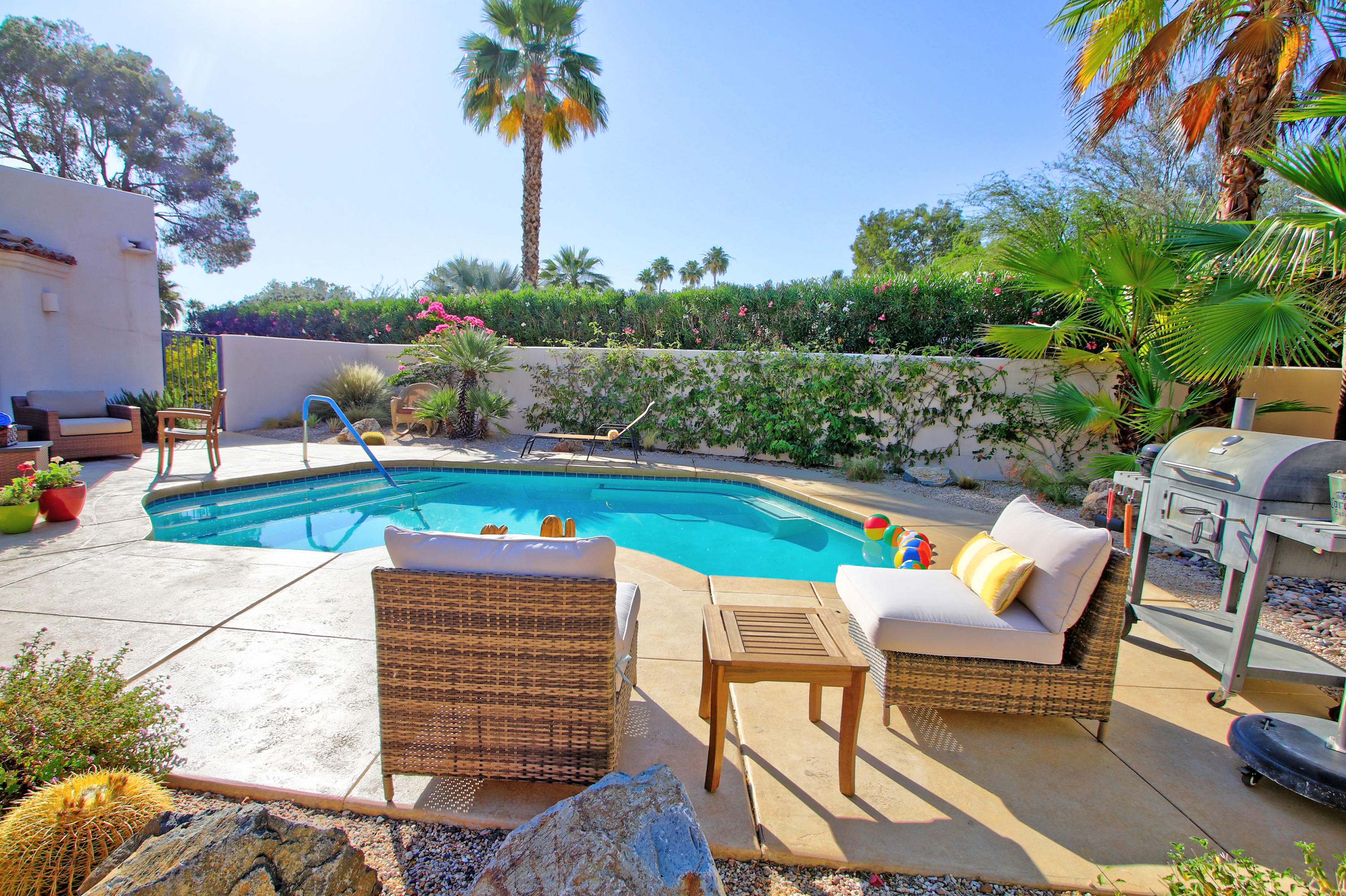 42490 Dunes View Road Rancho Mirage, CA 92270 - Photo 49 of 60 an outdoor sitting area with furniture and garden view