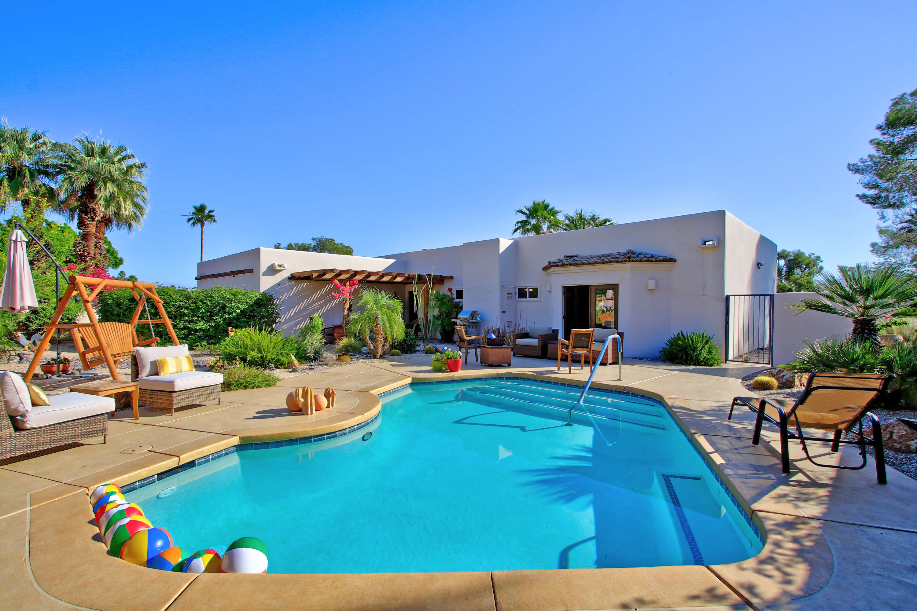 42490 Dunes View Road Rancho Mirage, CA 92270 - Photo 50 of 60 a view of a swimming pool with a lounge chairs