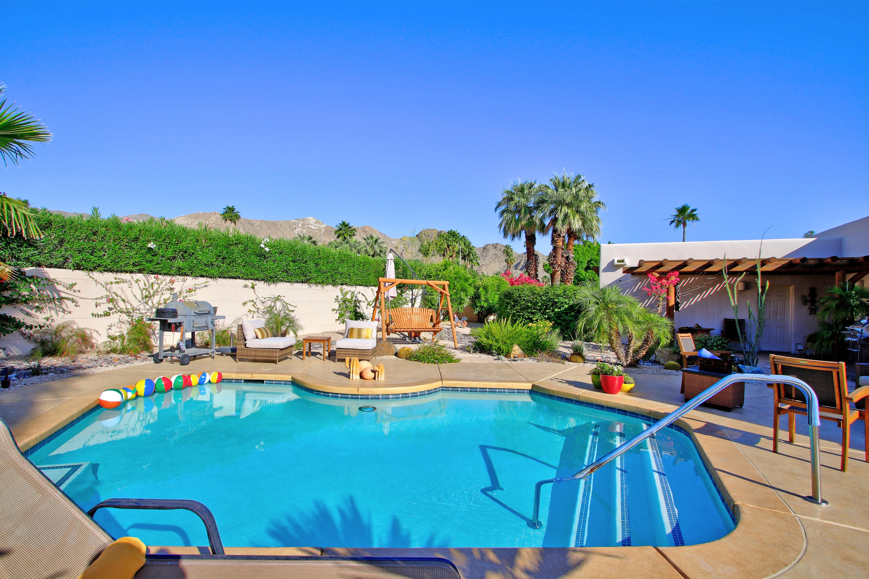 42490 Dunes View Road Rancho Mirage, CA 92270 - Photo 5 of 60 a view of a swimming pool with lounge chairs