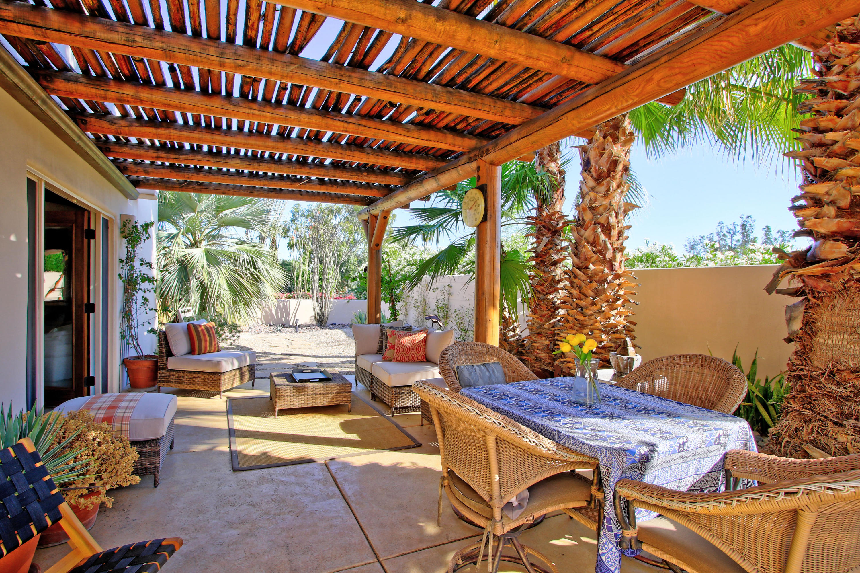 42490 Dunes View Road Rancho Mirage, CA 92270 - Photo 51 of 60 a view of a patio with a table chairs and a swimming pool