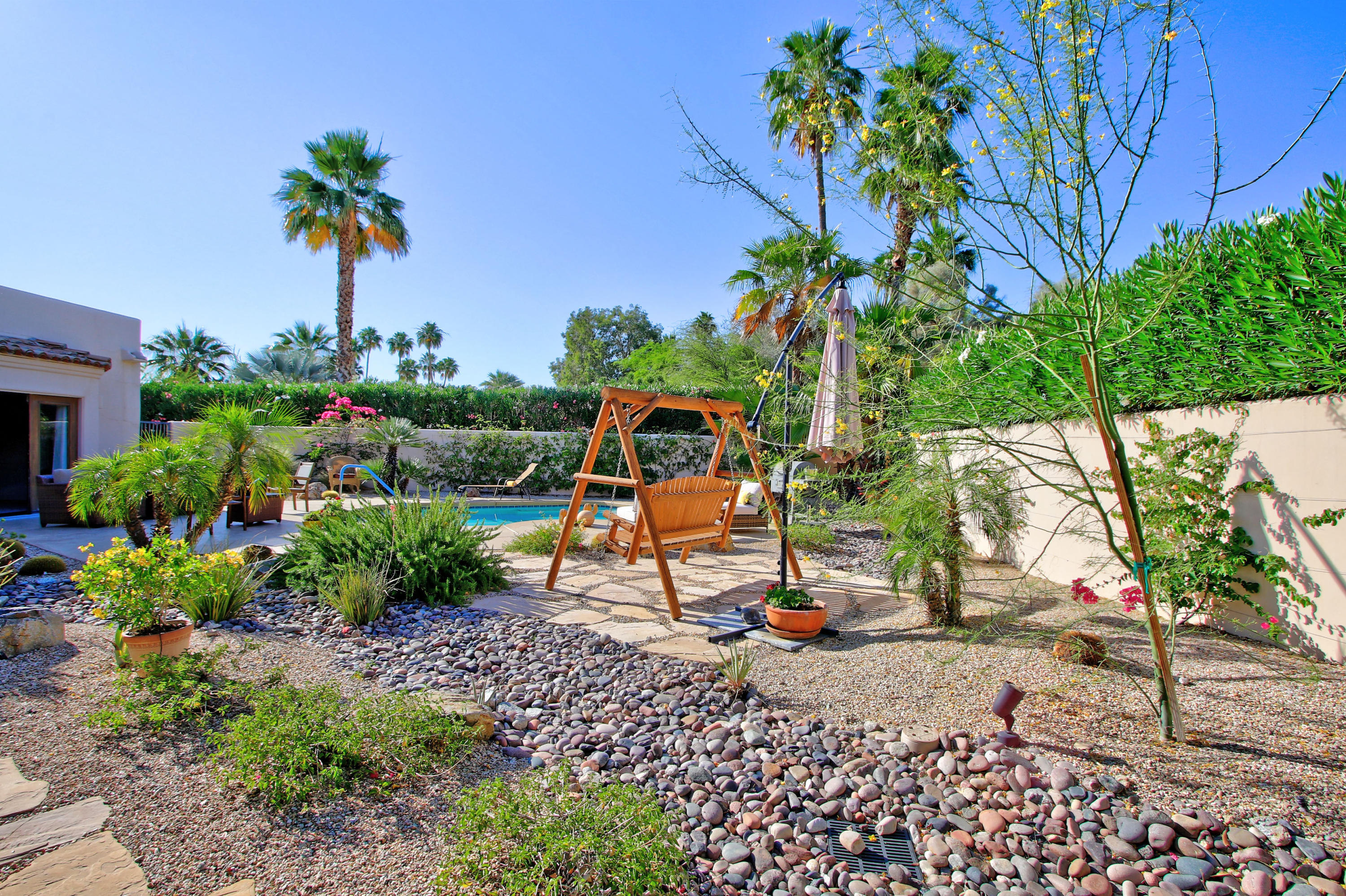 42490 Dunes View Road Rancho Mirage, CA 92270 - Photo 10 of 60 a backyard of a house with a garden and outdoor seating