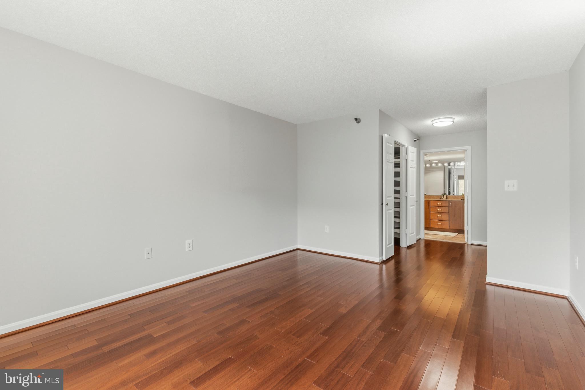 14801 Pennfield Circle, Unit 206 Silver Spring, MD 20906 - Photo 15 of 37 a view of an empty room with wooden floor