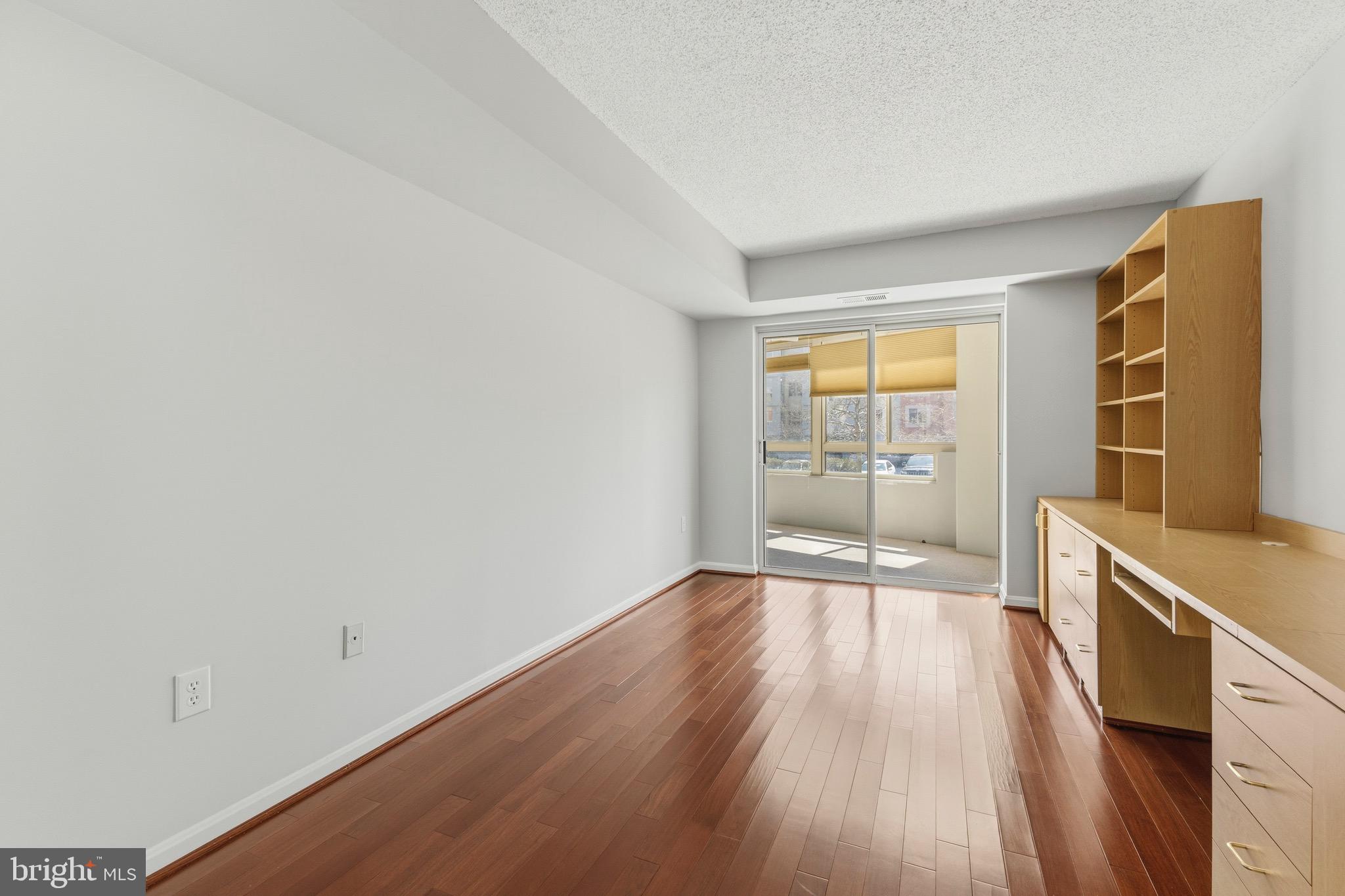 14801 Pennfield Circle, Unit 206 Silver Spring, MD 20906 - Photo 21 of 37 an empty room with wooden floor and windows