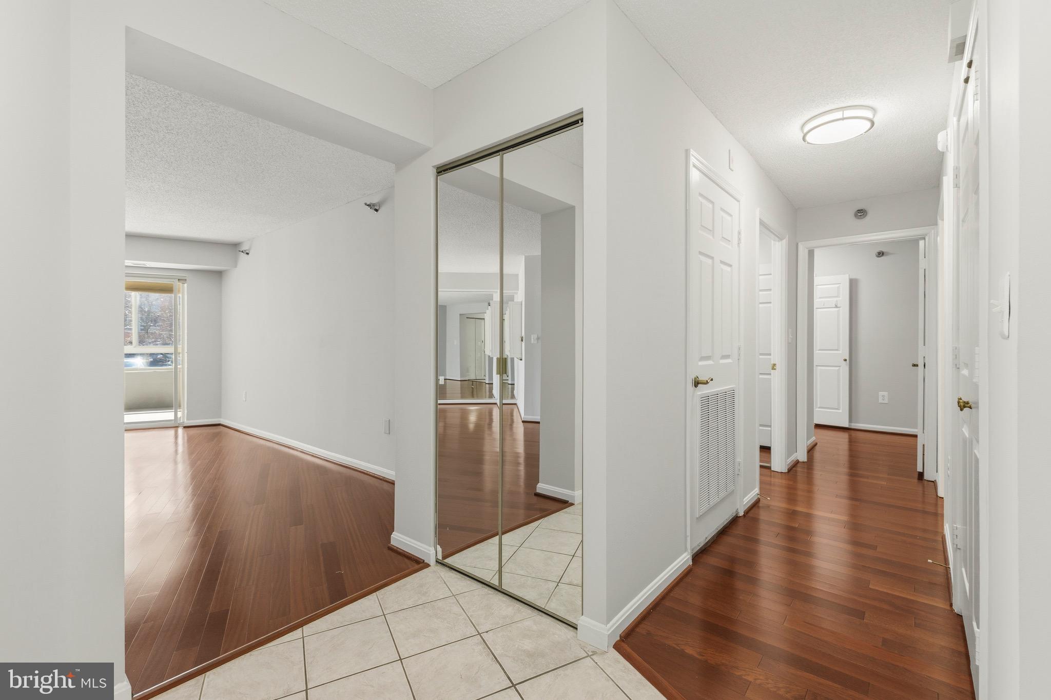 14801 Pennfield Circle, Unit 206 Silver Spring, MD 20906 - Photo 4 of 37 a view of a hallway with wooden floor