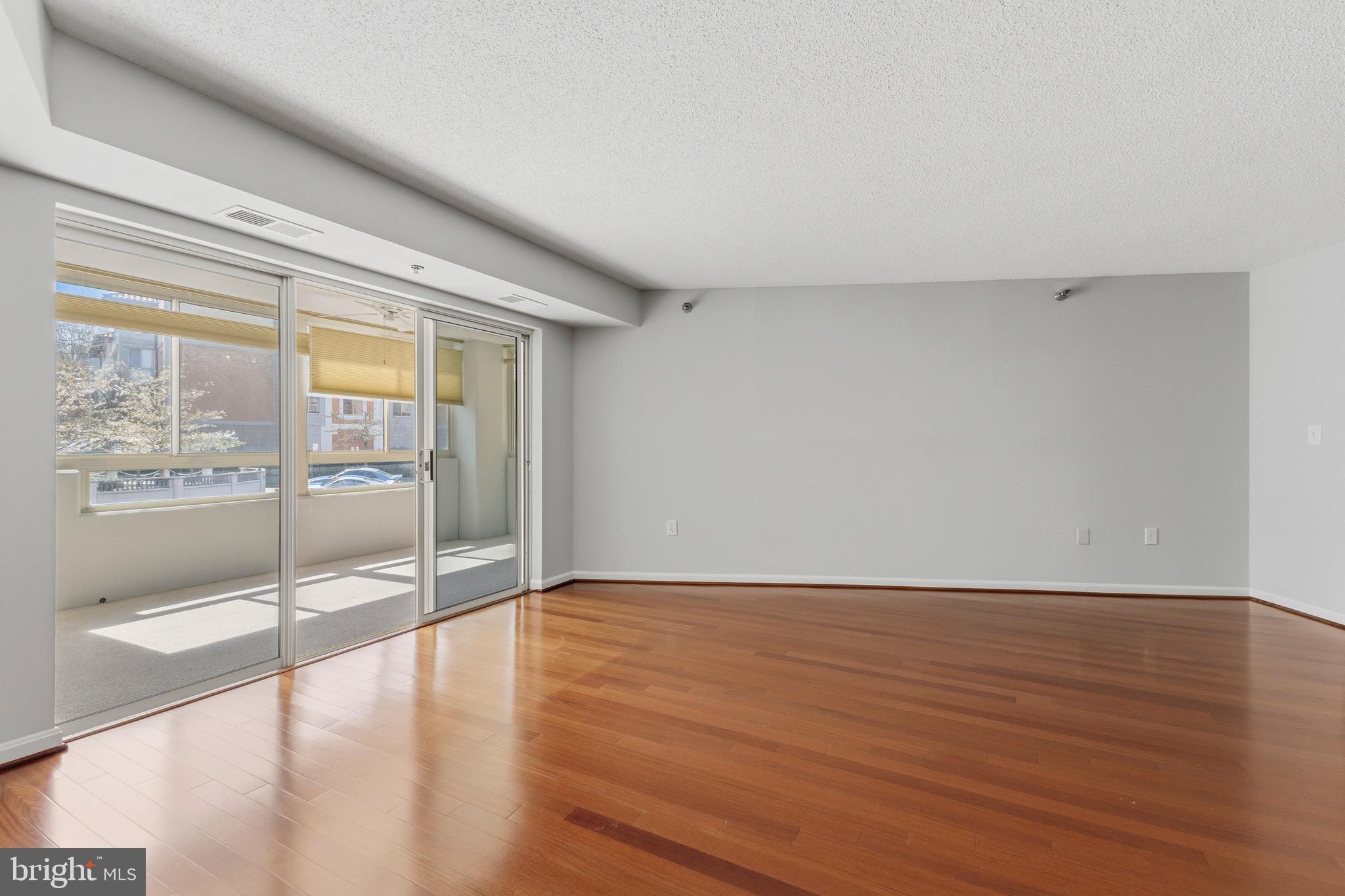 14801 Pennfield Circle, Unit 206 Silver Spring, MD 20906 - Photo 8 of 37 wooden floor in an empty room with a window