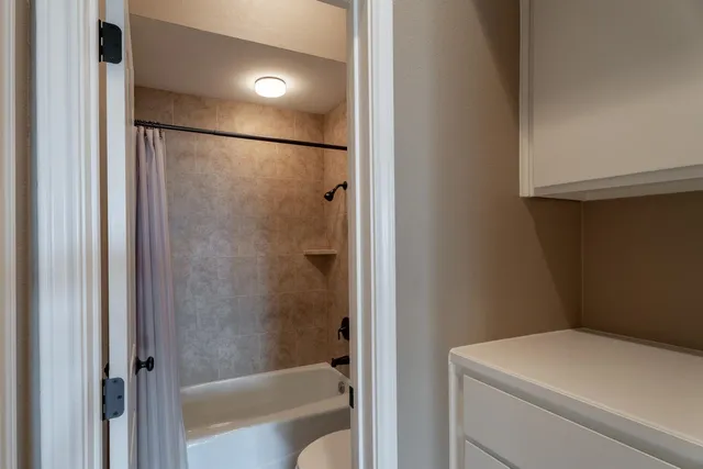 a bathroom with a shower and a toilet
