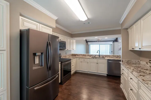 a kitchen with a refrigerator stove and sink