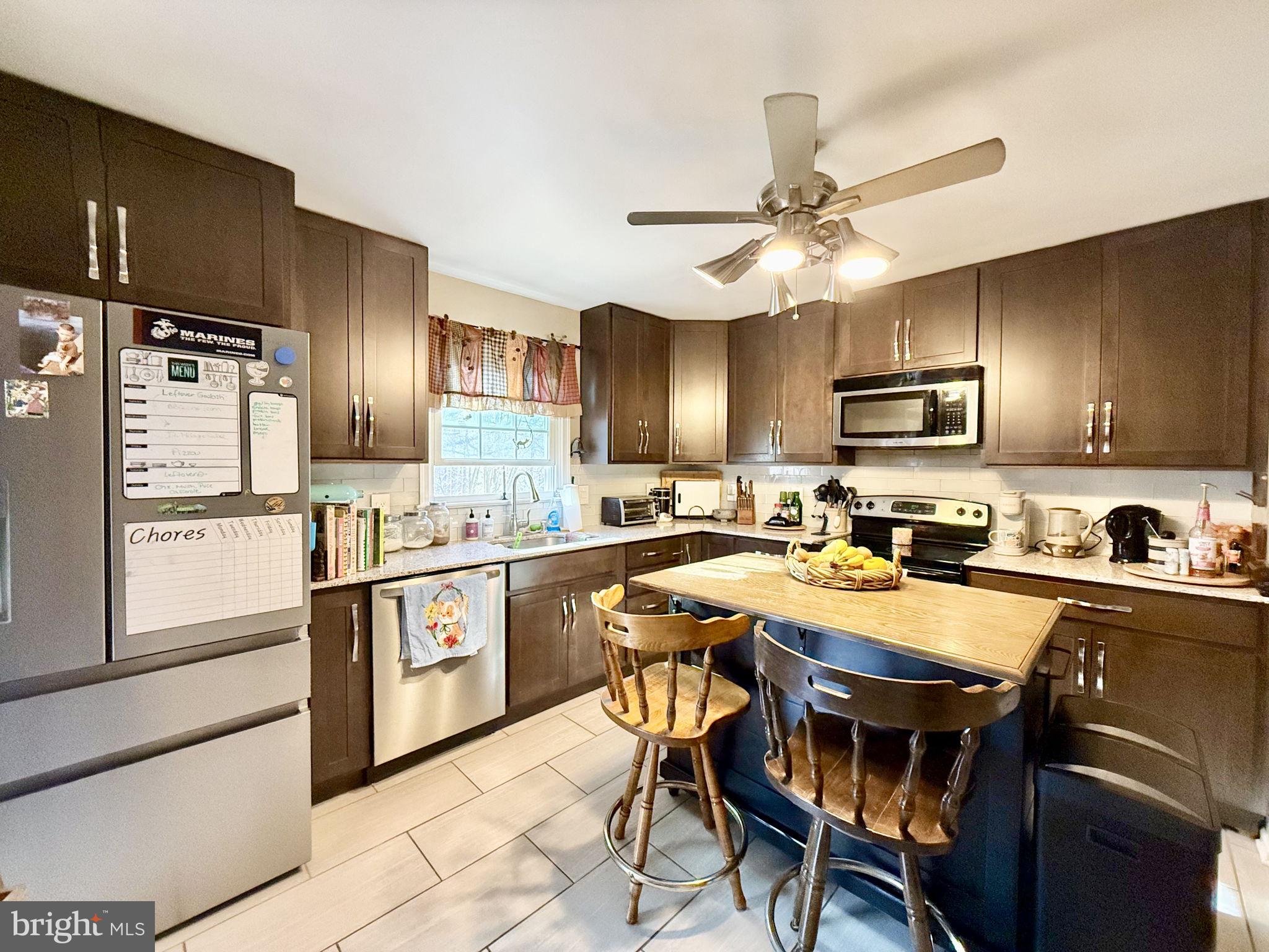 8 Rolling Road Stafford, VA 22556 - Photo 5 of 22 a kitchen with granite countertop a sink appliances cabinets and furniture