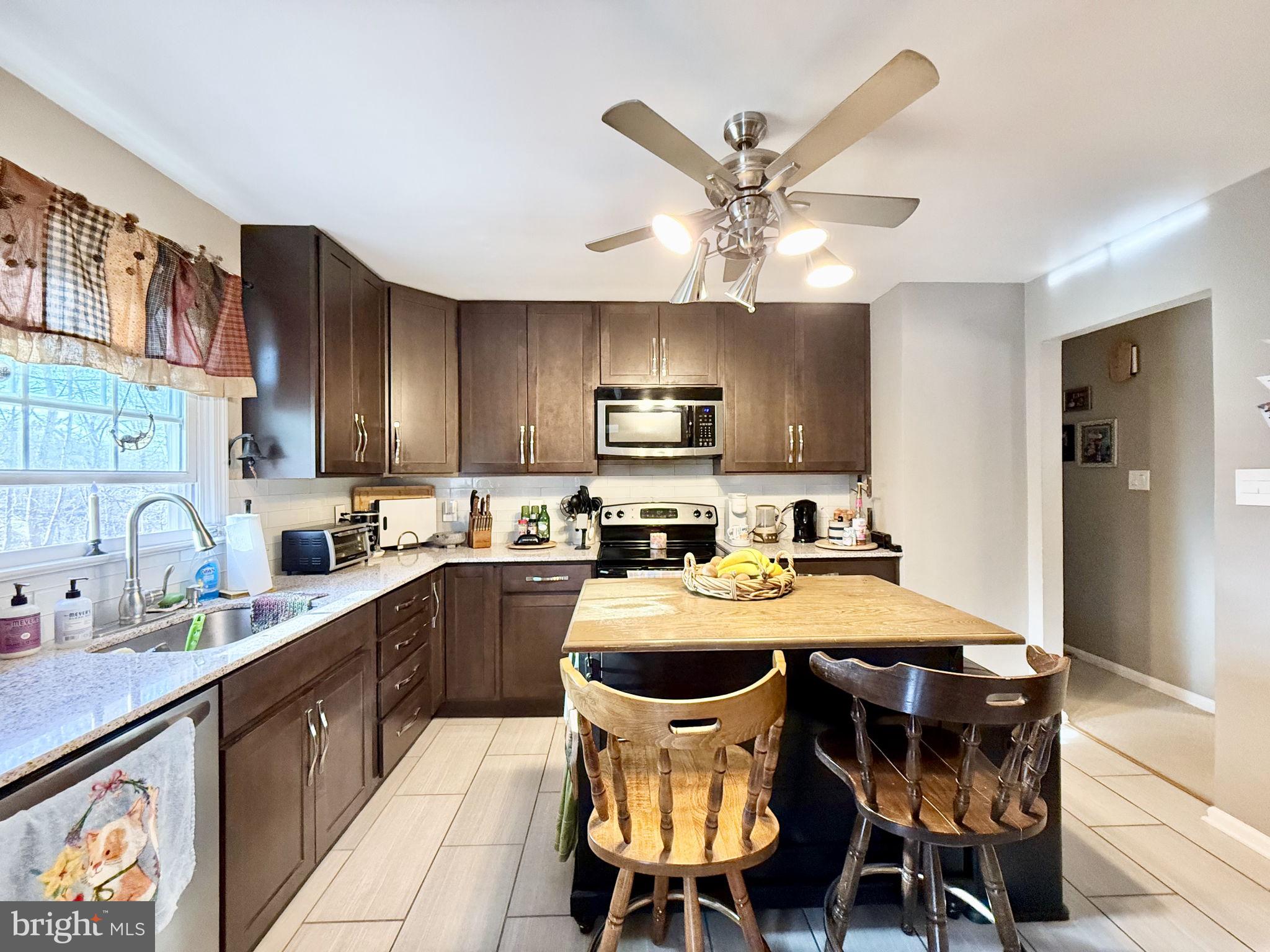 8 Rolling Road Stafford, VA 22556 - Photo 7 of 22 a kitchen with a dining table chairs and refrigerator