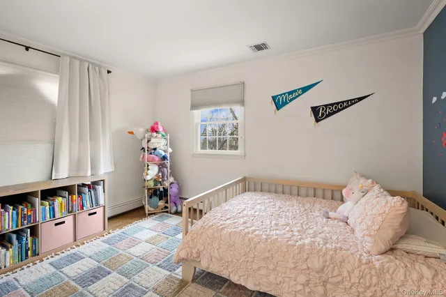 a bedroom with a bed and a book shelf