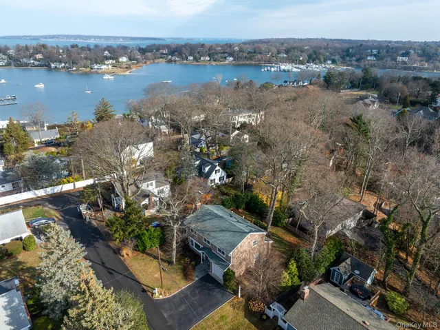 an aerial view of ocean with residential house and lake