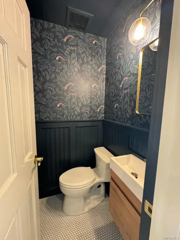 a white toilet sitting next to a shower curtain