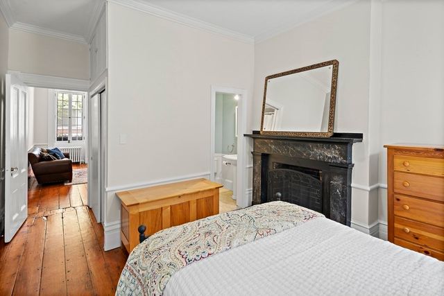 a bedroom with a bed and a fireplace