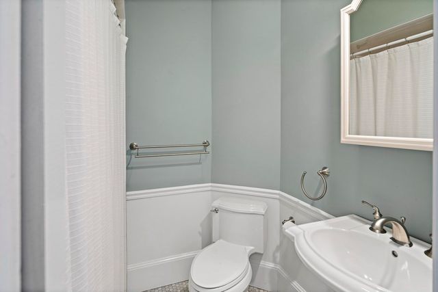 a white toilet sitting next to a bathroom sink