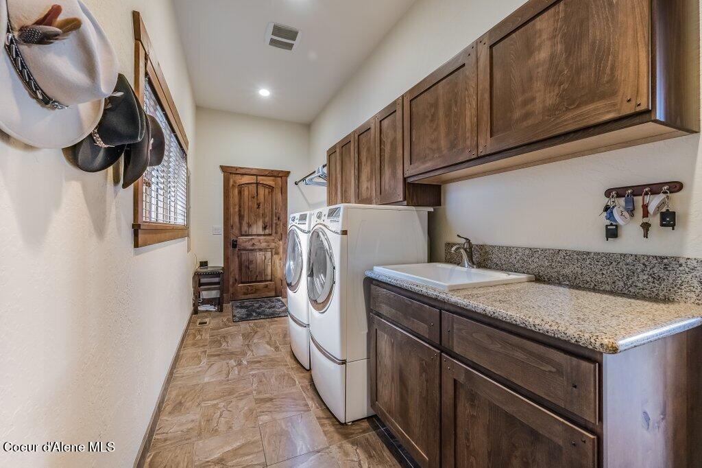 5071 South Fishhawk Court Harrison, ID 83833 - Photo 24 of 100 Laundry with Custom Alder Cabinetry