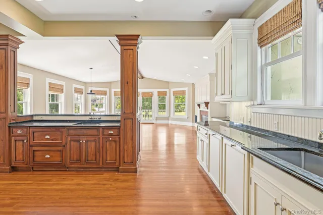 a large kitchen with granite countertop a large window and a sink