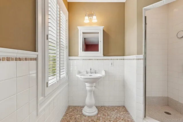 a bathroom with a sink a mirror and a shower