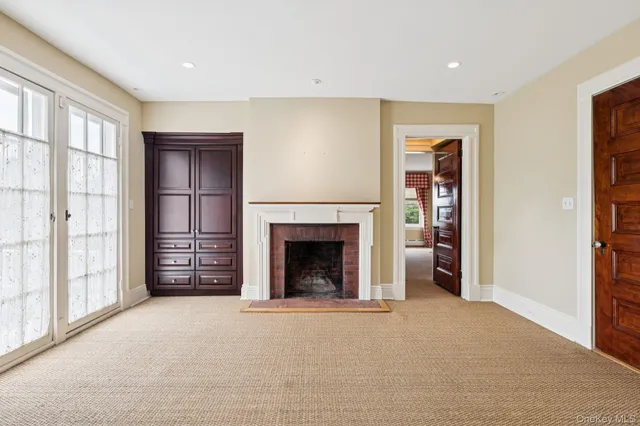 an empty room with furniture and a fireplace
